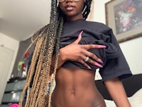 a black woman in a bikini posing for a photo